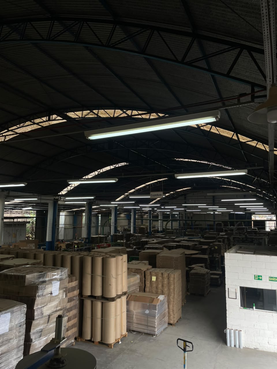 Galpão de produção da Embalagens Confiança, com bobinas de papelão e caixas paletizadas